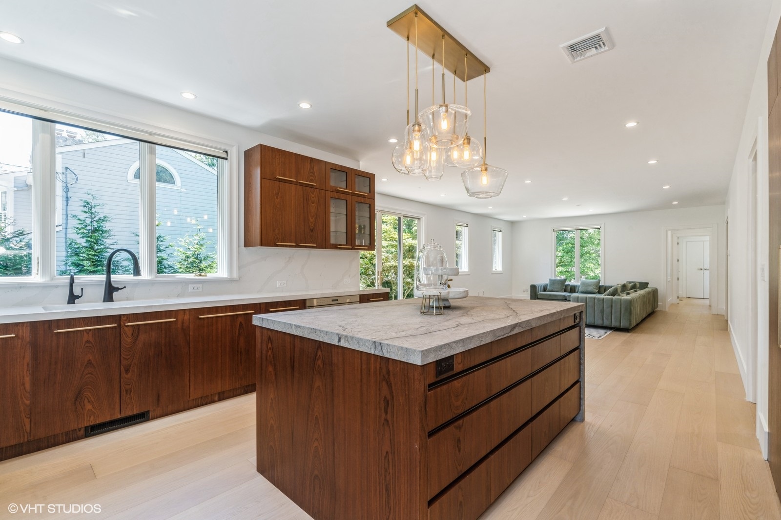 Bespoke Bottega walnut kitchen, stone island, and open living space